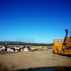 Up at the Molokai Dump, the bulldozer gets ready to turn trash into a mountain.
