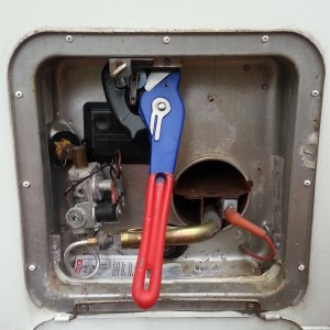Pipe wrench in the water heater on the leaky pressure relief valve. If you don't reconnect that tube at the bottom left tightly when you're done, it throws fireballs up the side of your camper.